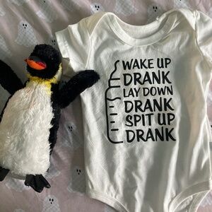 Six month old baby onesie, and SeaWorld penguin plushy